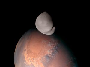 Emirates Mars Mission view of Deimos in front of Mars